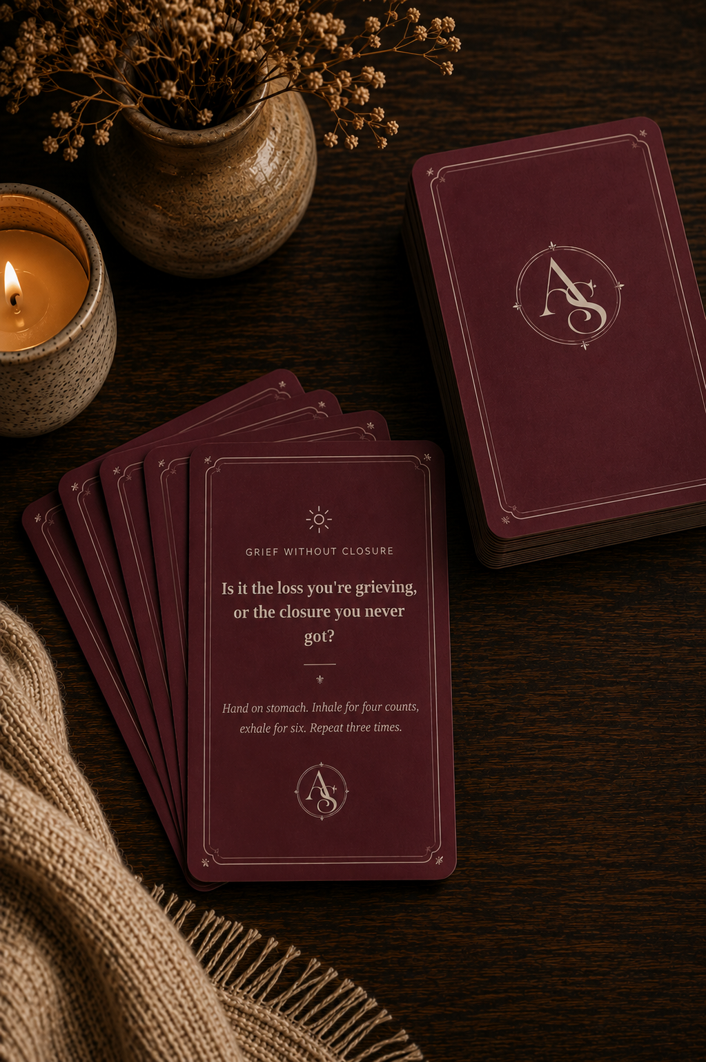 Relationship Energy Deck — burgundy cards fanned out on a dark wood table